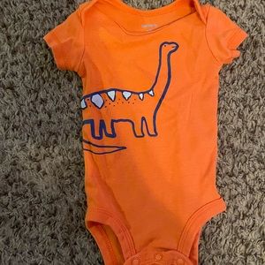 Two dinosaur onesies